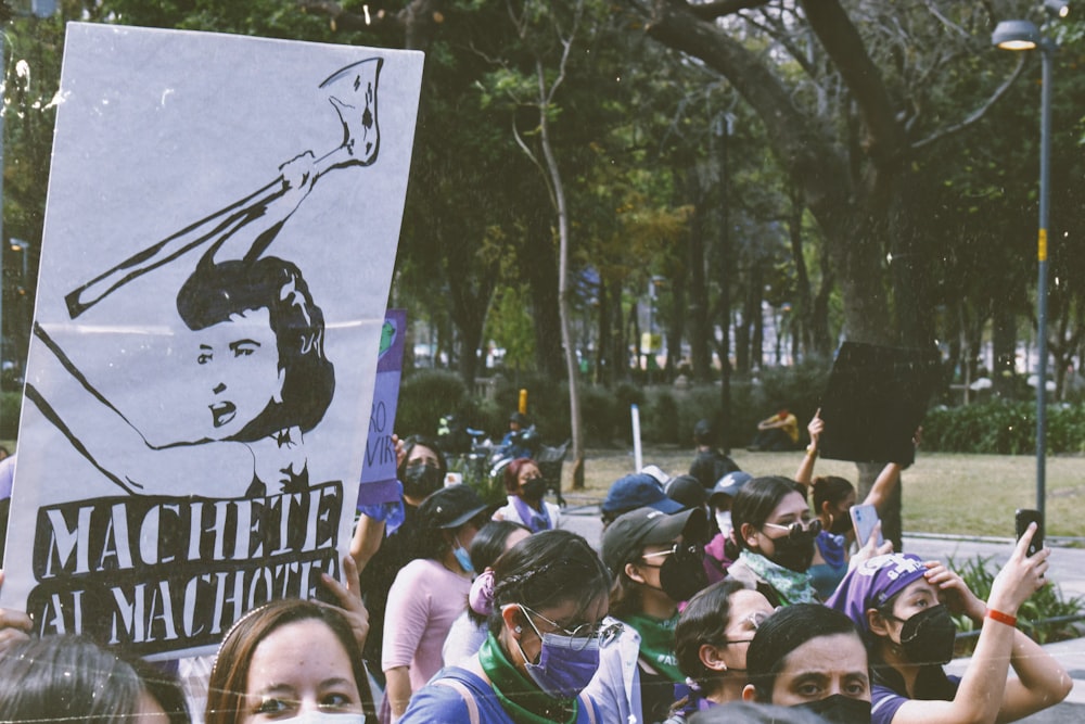 a large group of people holding up signs