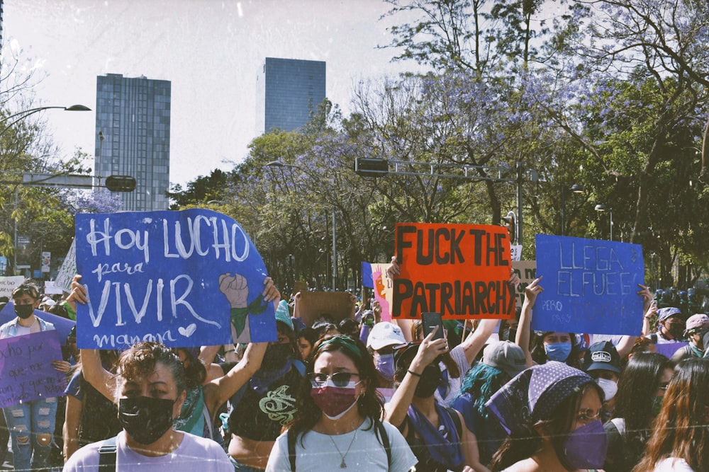 a group of people holding up signs in the air