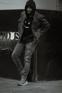 Model leaning against a dark wall wearing a casual t-shirt with a witty print.