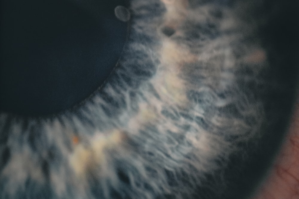 a close up of an eye with clouds in the iris