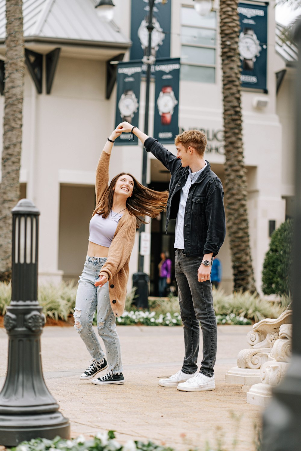 a man and a woman dancing in front of a building