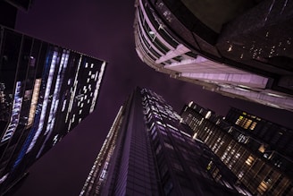 looking up at skyscrapers at night in the city