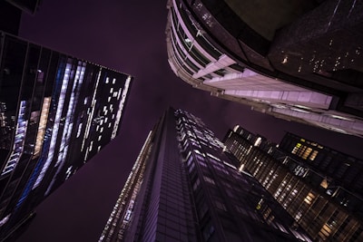 looking up at skyscrapers at night in the city