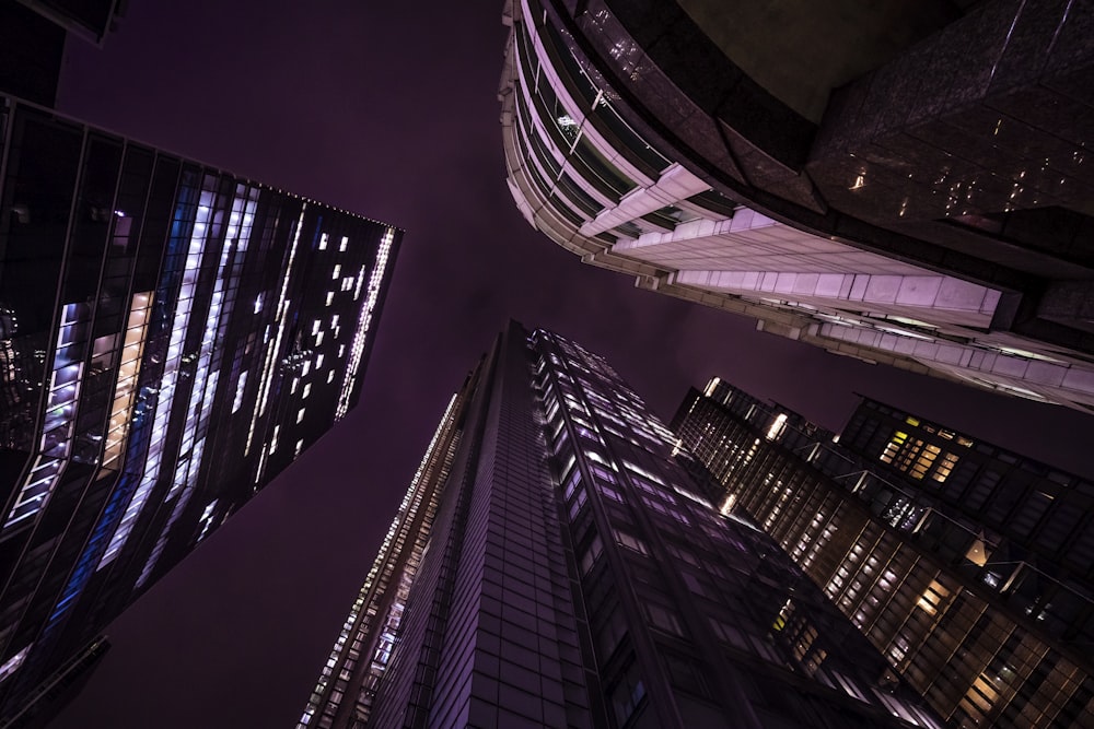 looking up at skyscrapers at night in the city