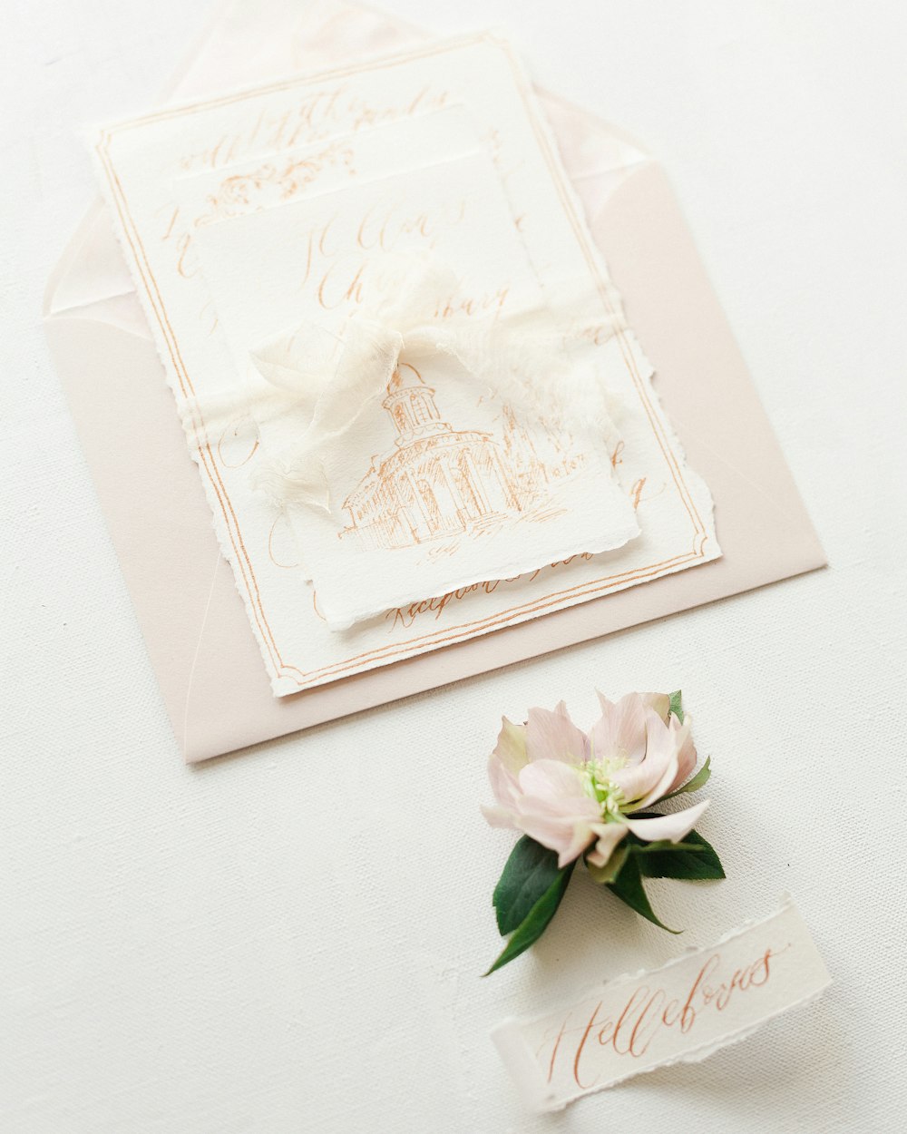 a close up of a wedding card and a flower