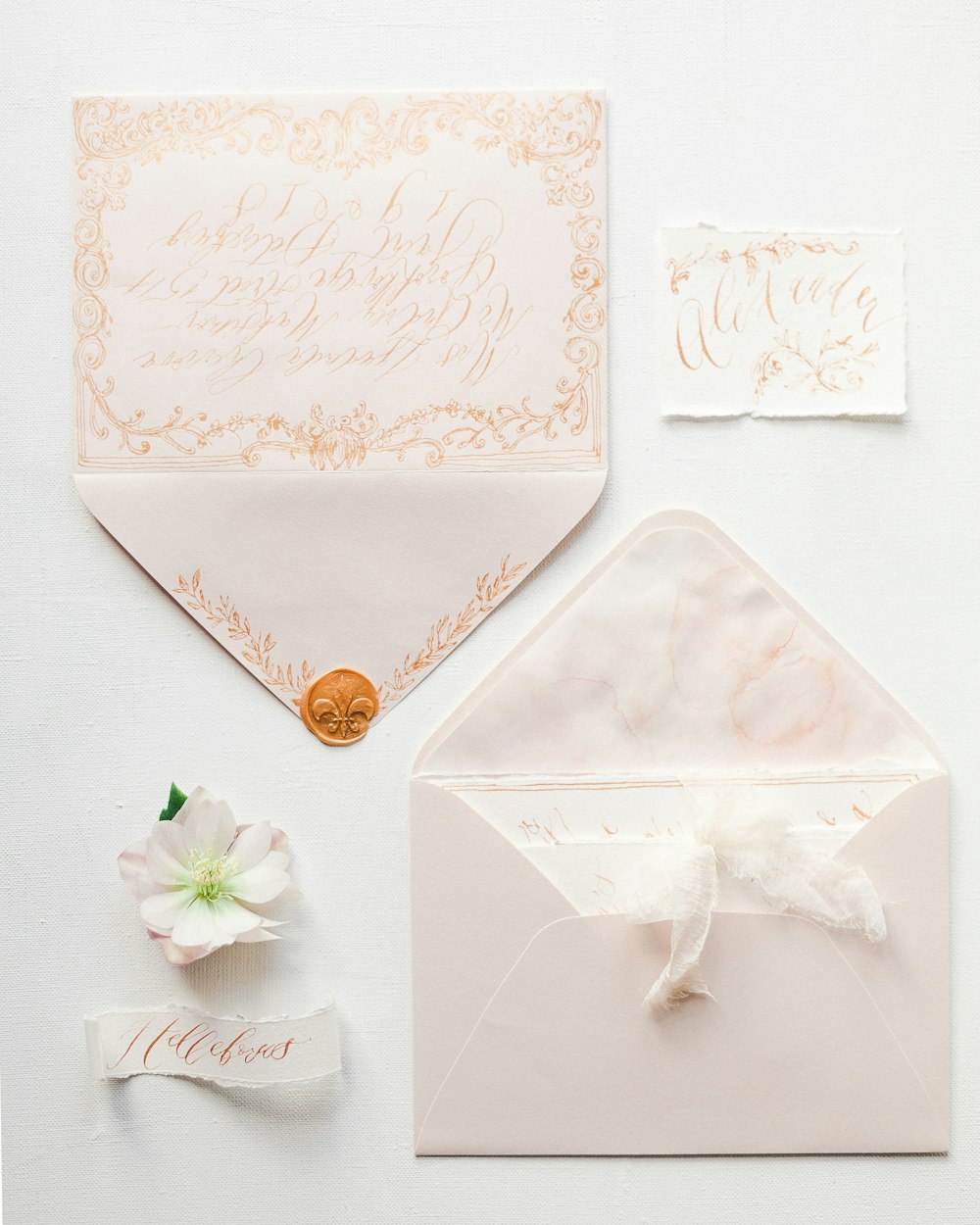 a white envelope with a ribbon and a flower