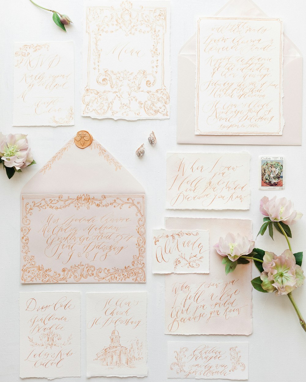 wedding stationery and envelopes laid out on a table
