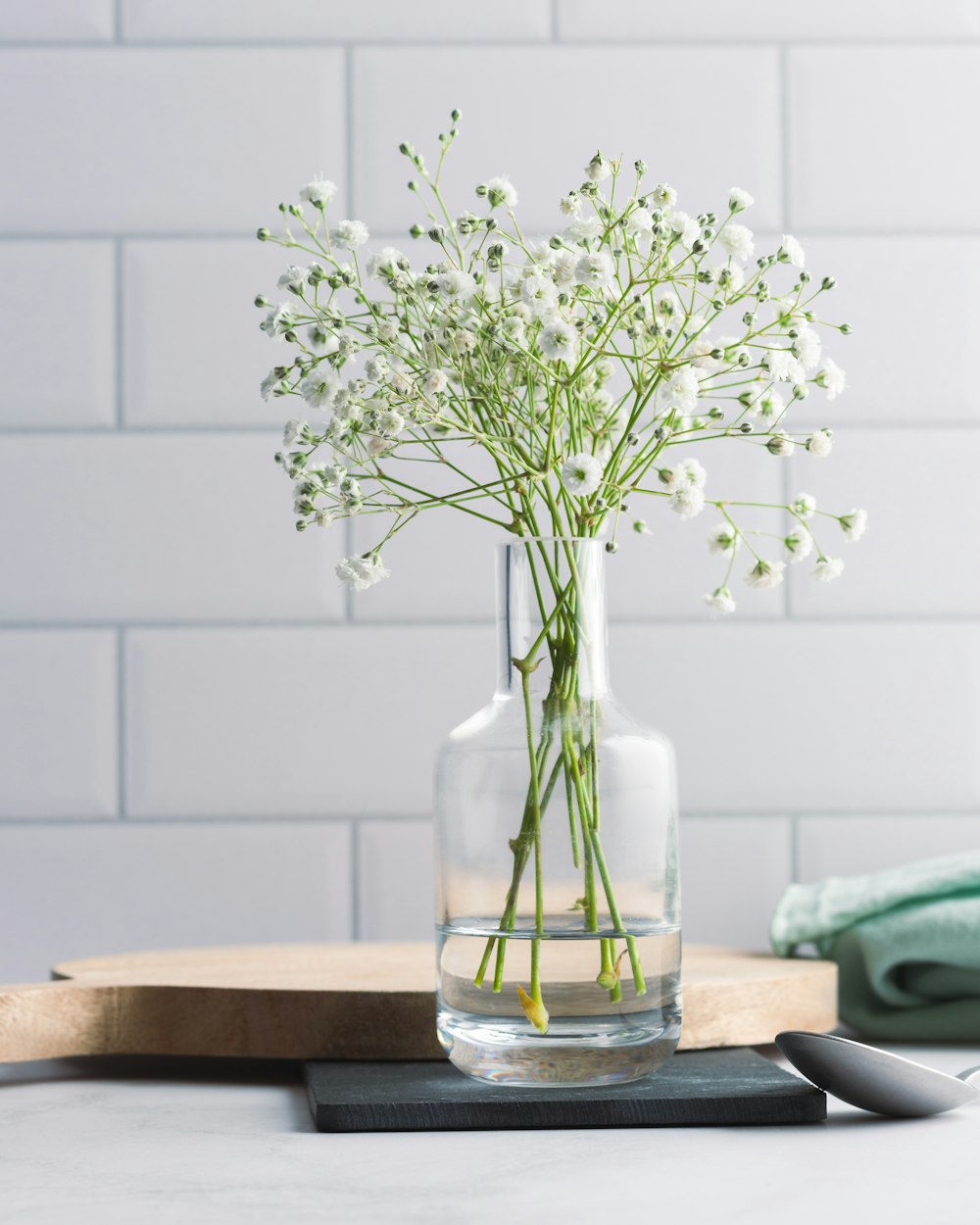 a vase filled with white flowers on top of a table