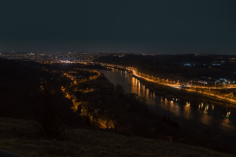a night time view of a city and a river