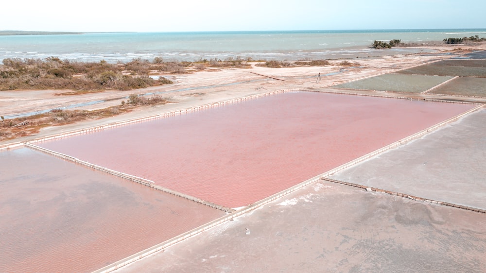 an aerial view of a large salt flat near the ocean