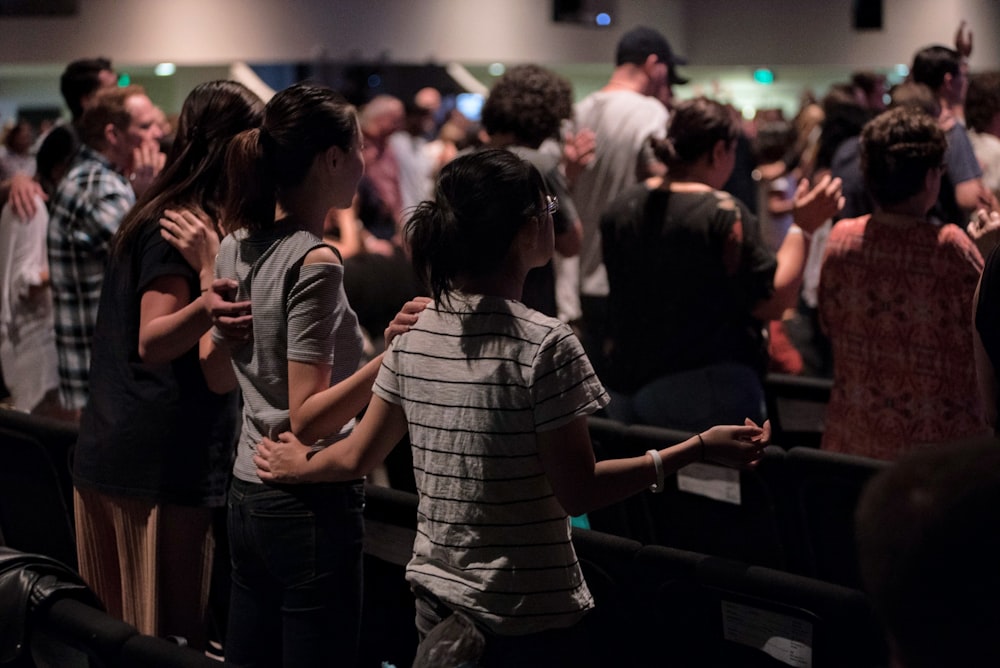 a group of people standing in front of a crowd of people