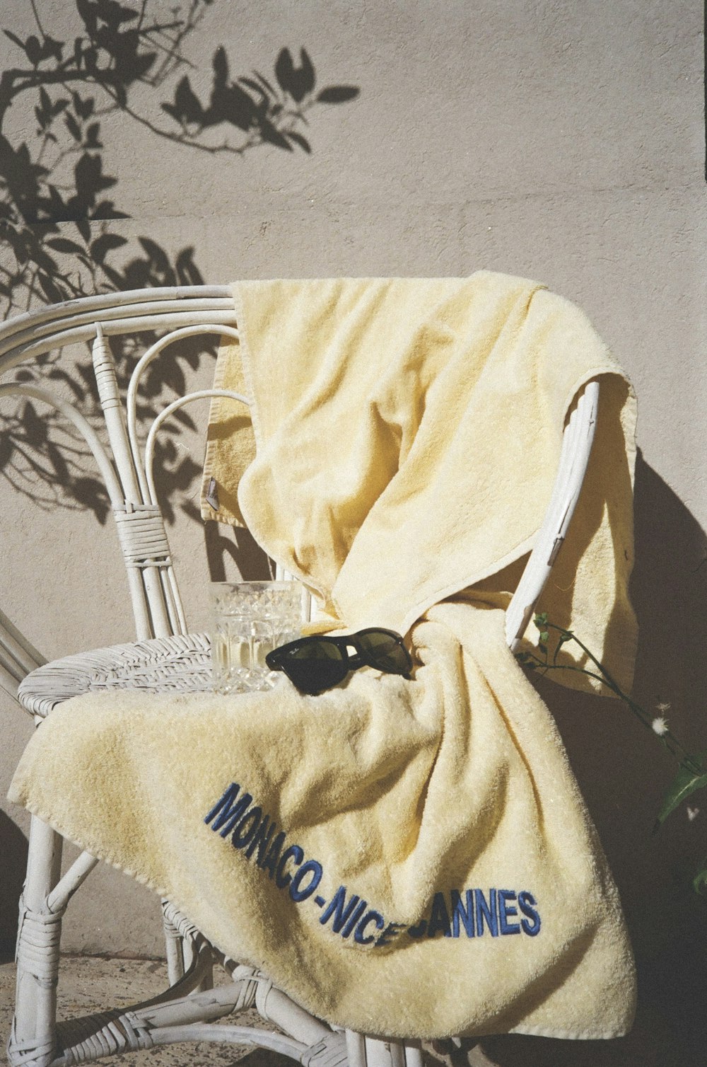 a white chair with a yellow towel on it