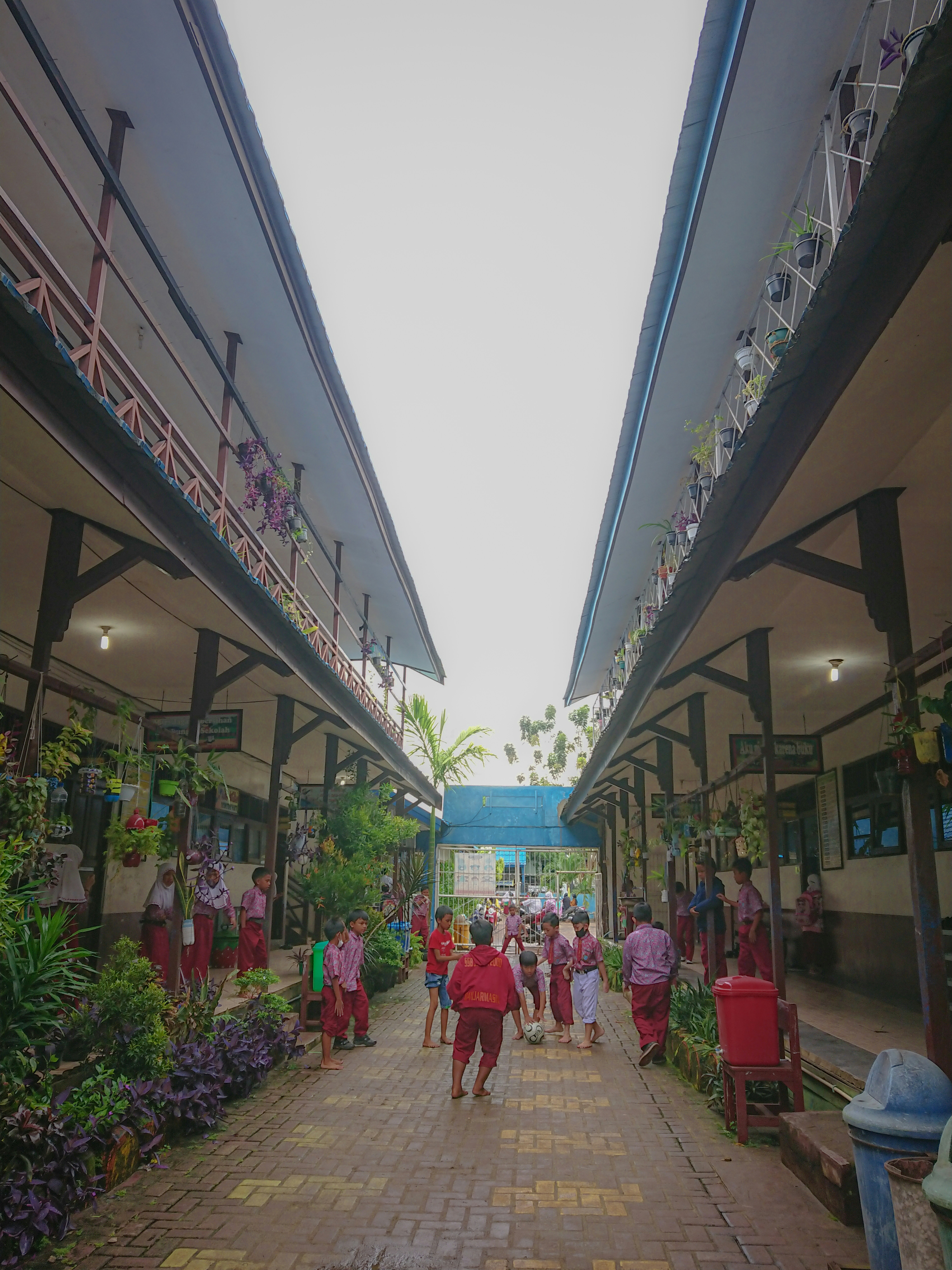 a group of people walking down a brick walkway