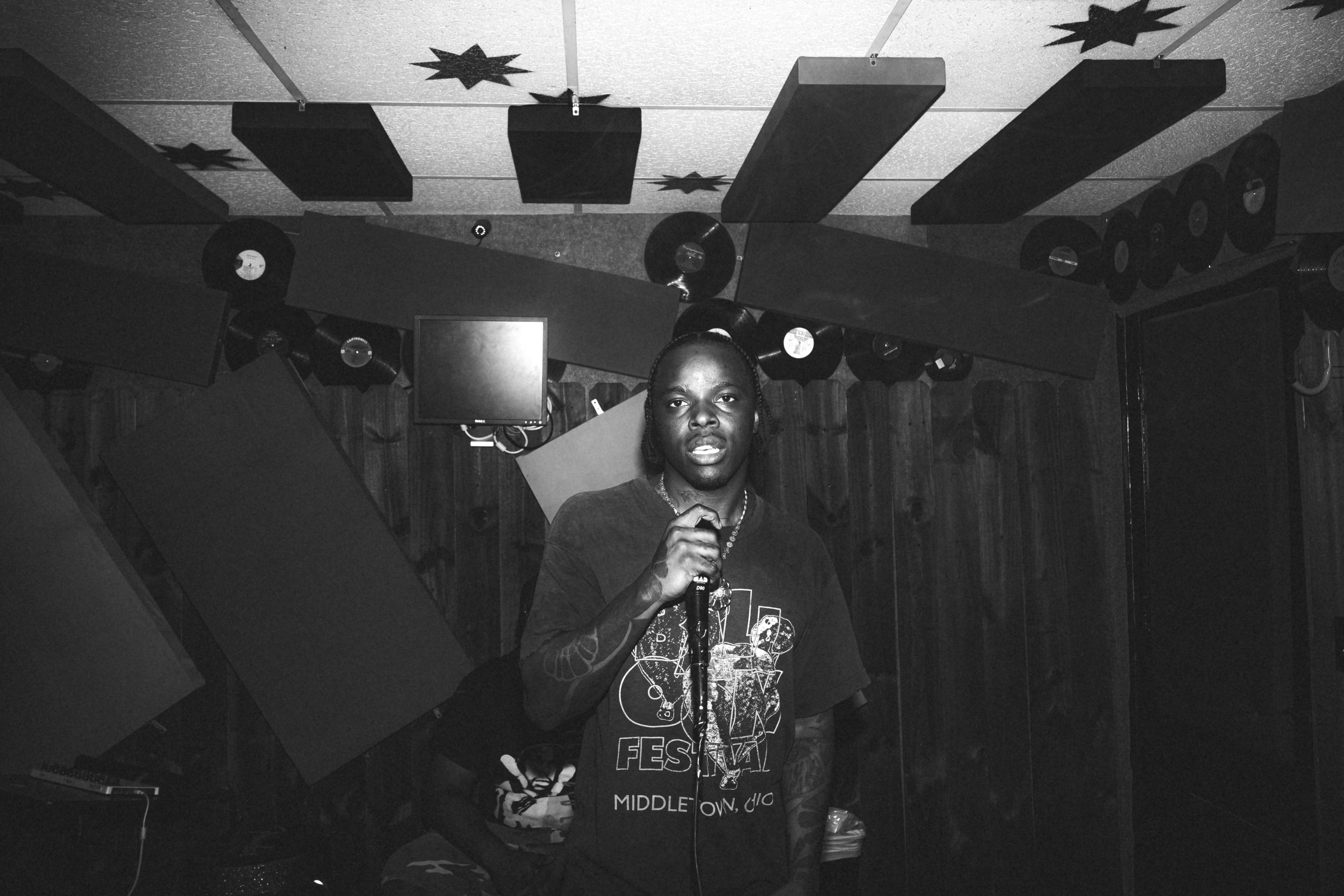 a man standing in a room with a microphone