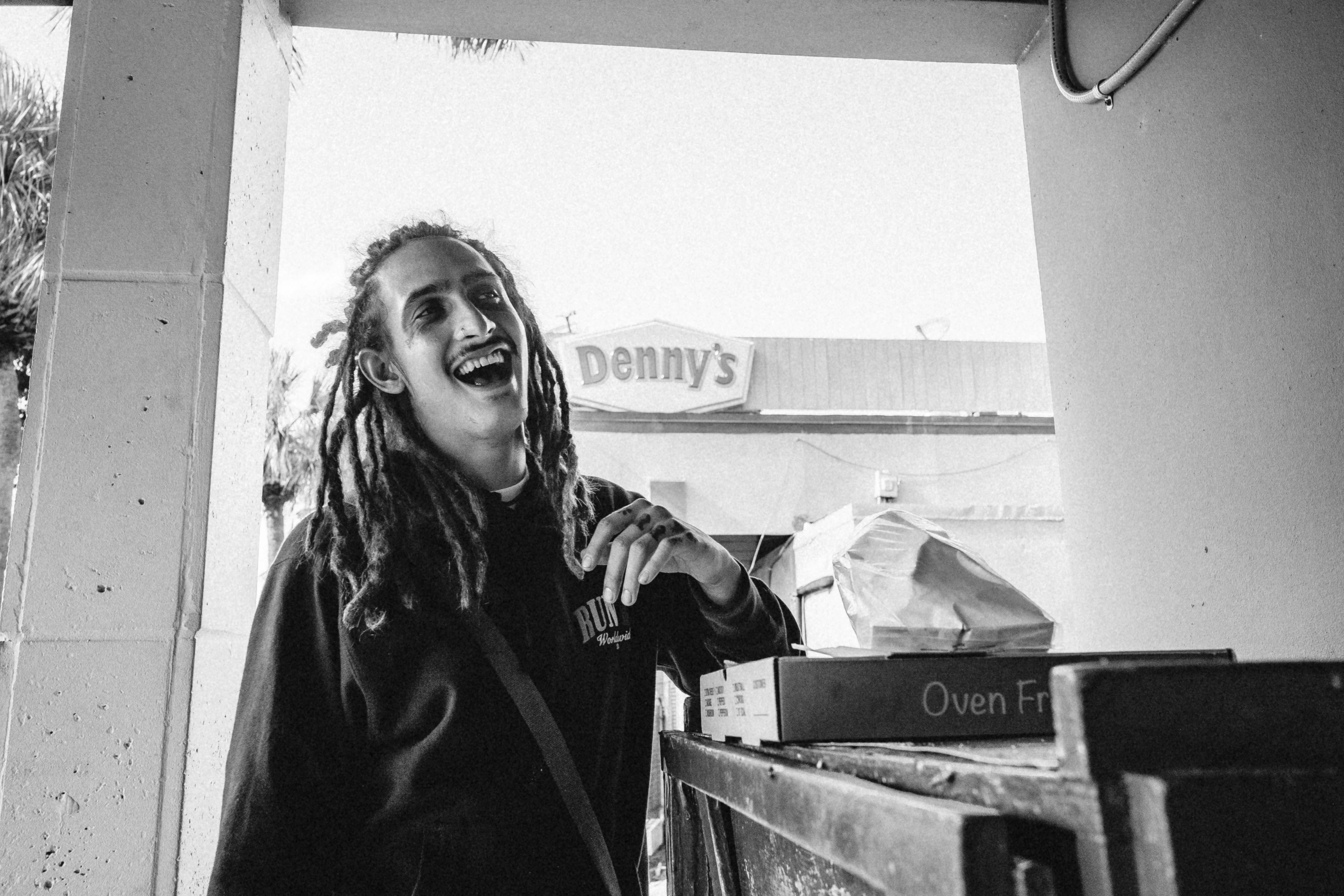 a woman with dreadlocks standing in front of a store (Photo by Frankie Cordoba on Unsplash)