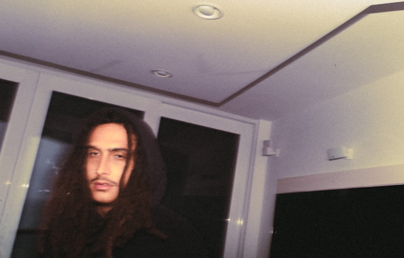 a man with long hair wearing a hoodie