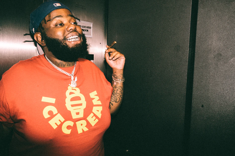 a man in a red shirt smoking a cigarette