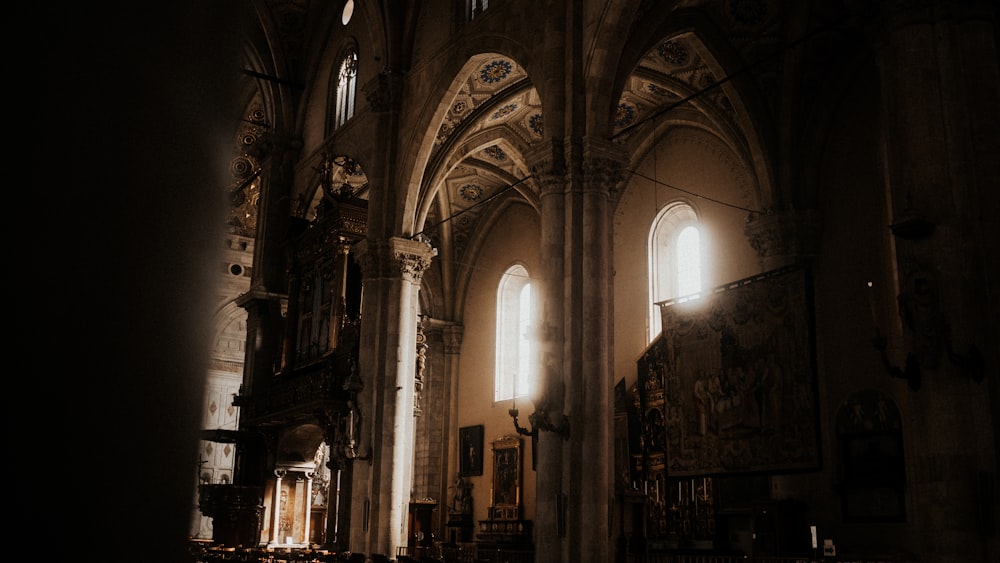 the interior of a church with sunlight coming through the windows