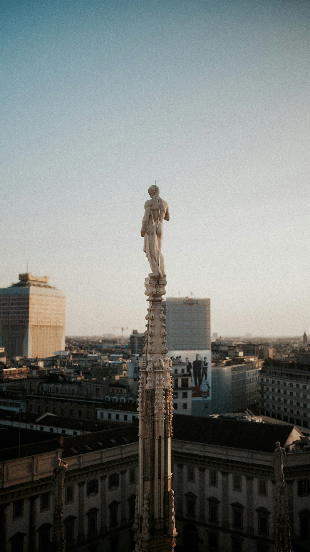 a statue on top of a building in a city