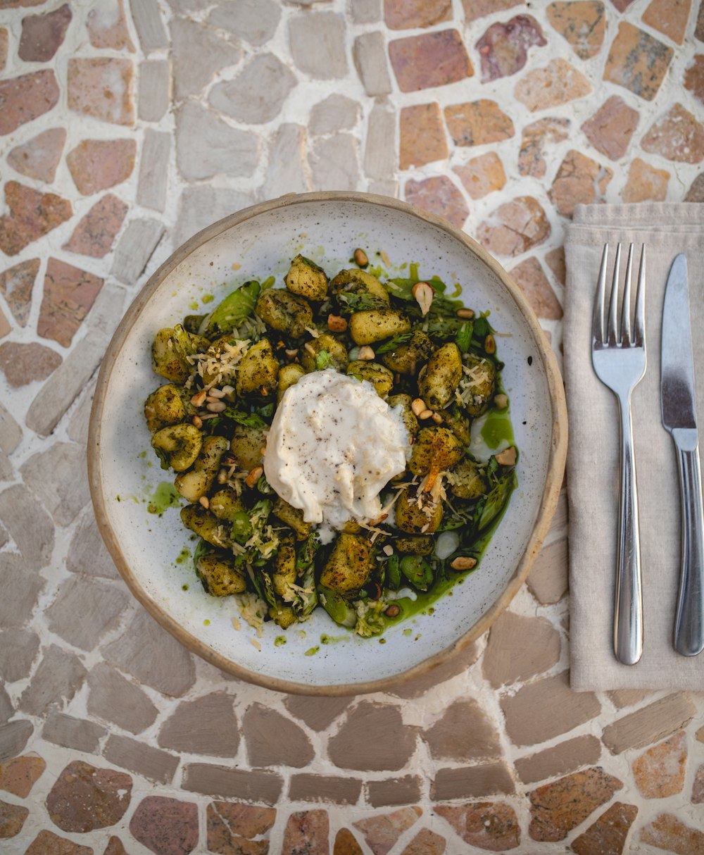 a white plate topped with brussel sprouts next to a fork and