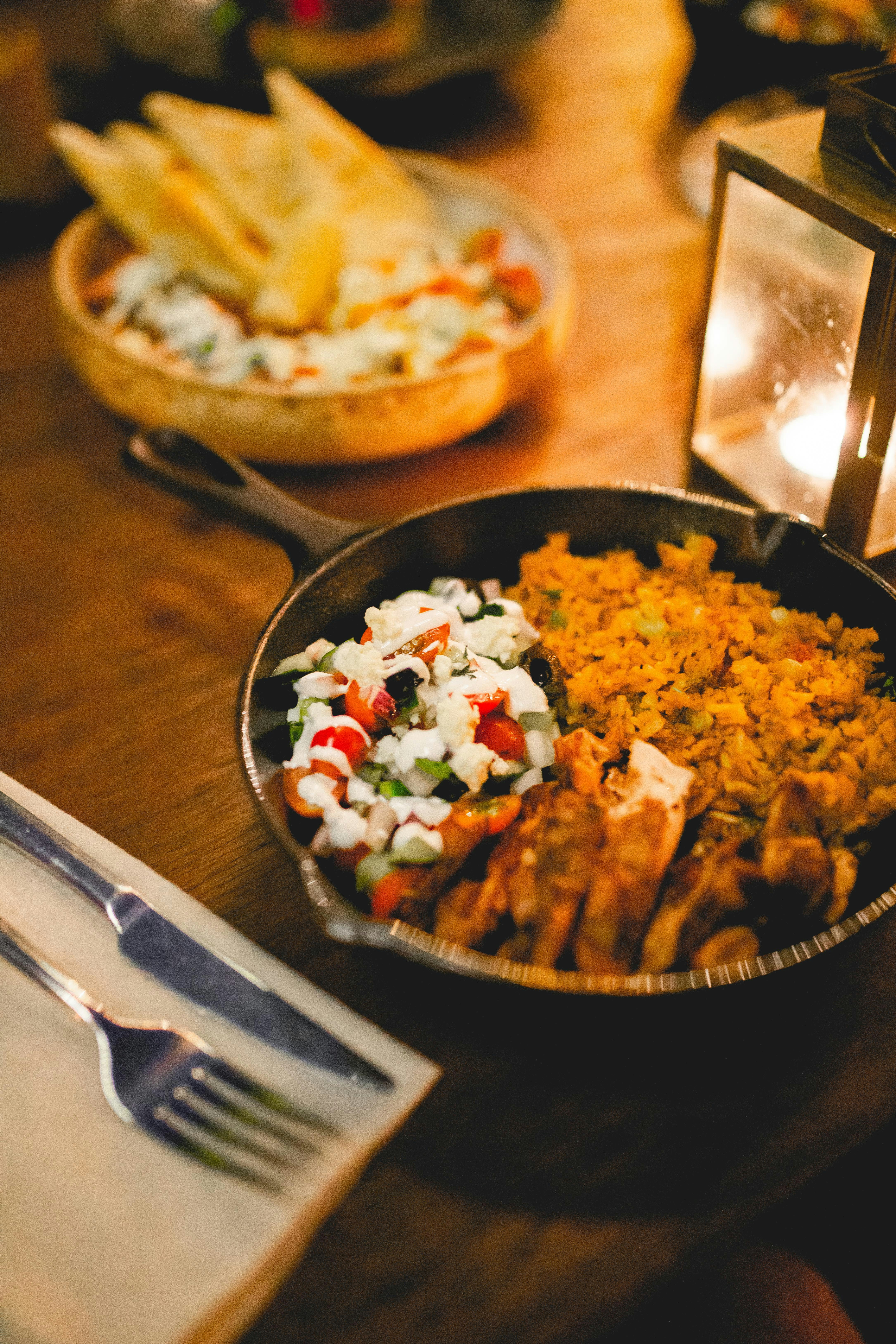 a pan filled with food sitting on top of a wooden table