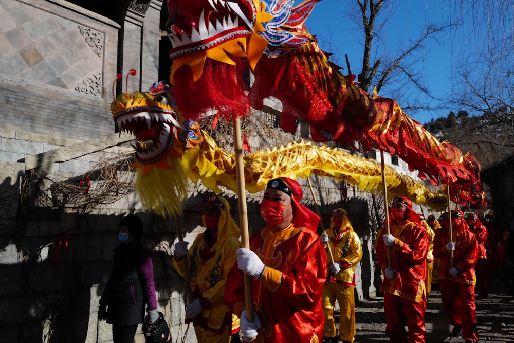 a group of people dressed in red and yellow