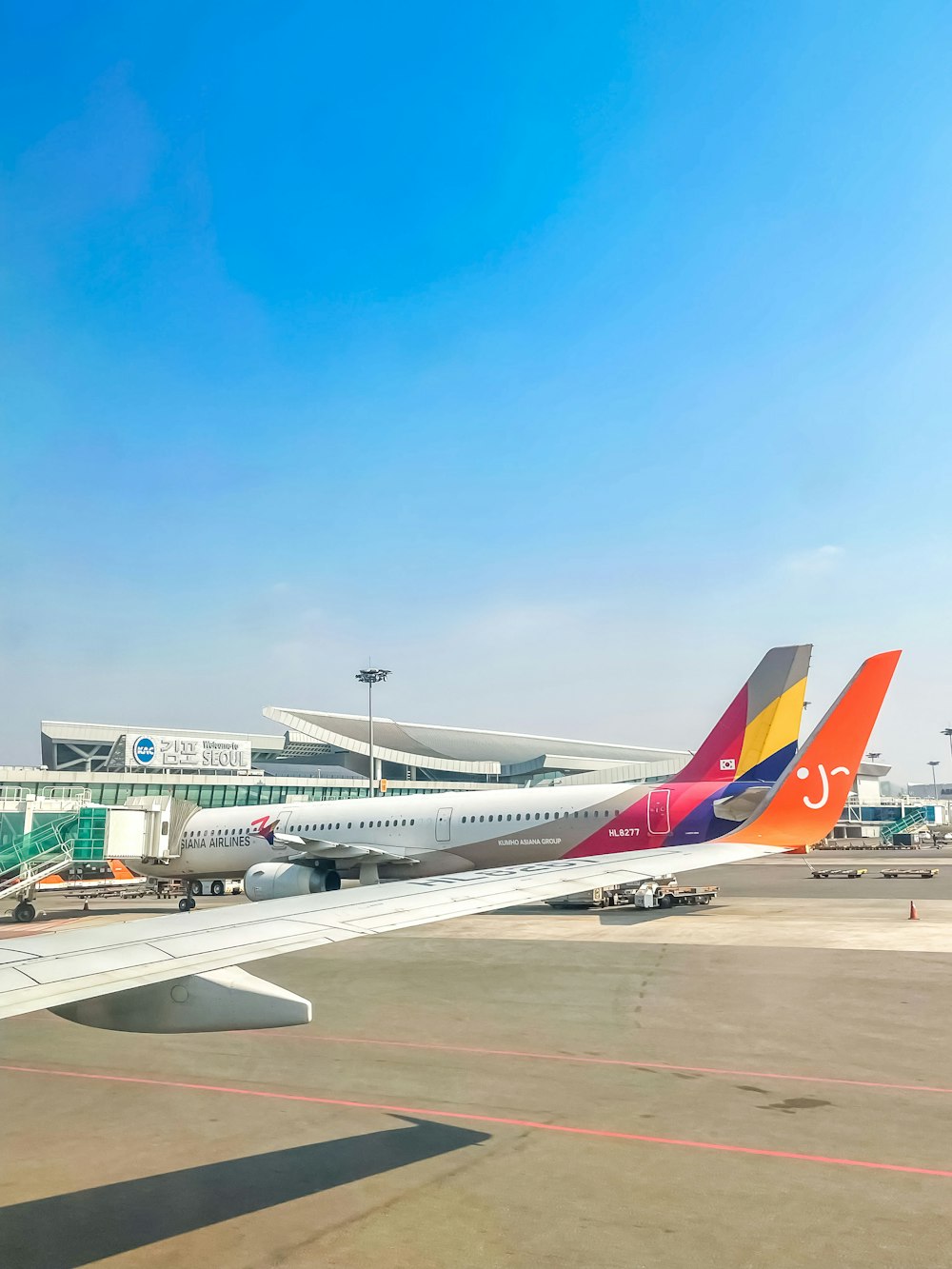 a colorful airplane is parked at an airport