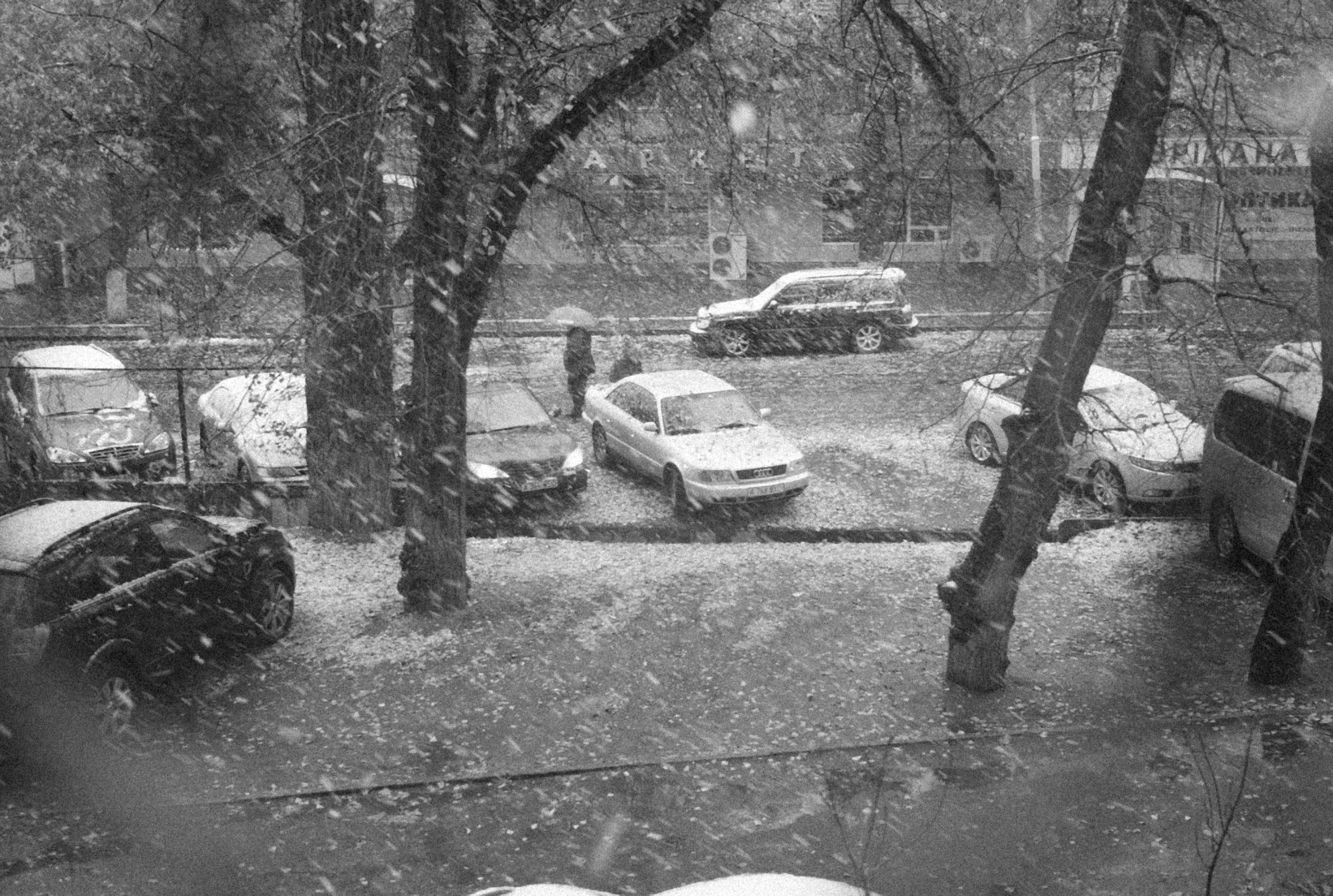 a black and white photo of a parking lot in the snow (Photo by Alexey Demidov on Unsplash)