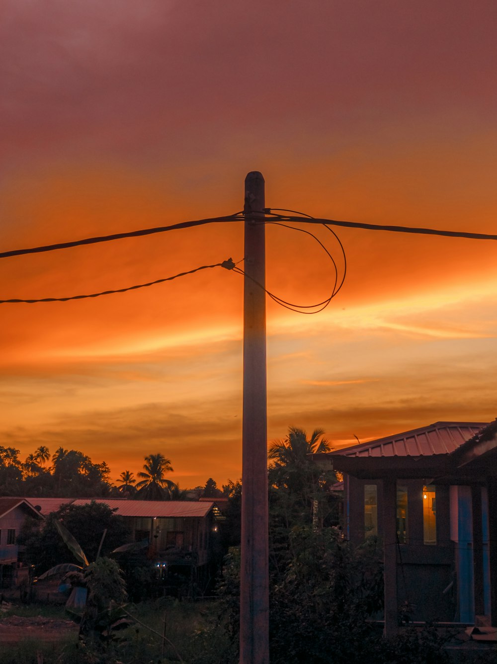 a telephone pole with a sunset in the background