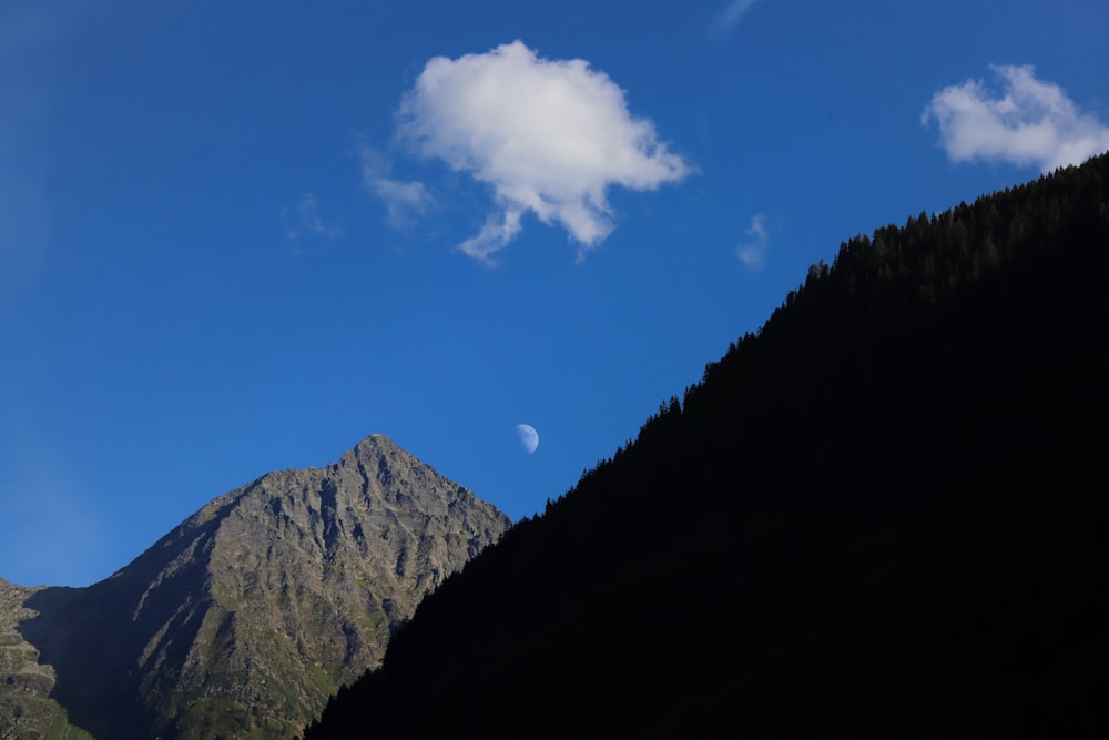 a view of a mountain with a cloud in the sky