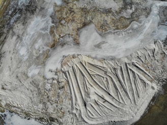 A panoramic view of Alberta's rugged foothills with geological layers visible, symbolizing mineral exploration.
