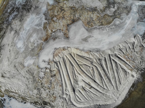 A panoramic view of a seismic survey team at work in a rugged landscape, with advanced equipment capturing underground data.