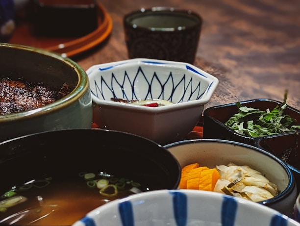 A close-up of traditional Japanese dishes showcasing fresh vegetables and fish.