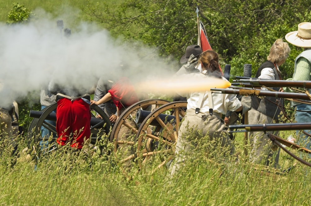 a group of people standing around a cannon