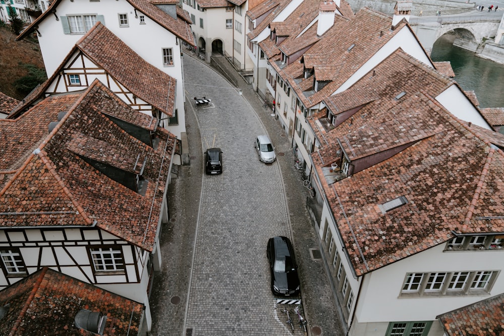 an aerial view of a street with parked cars