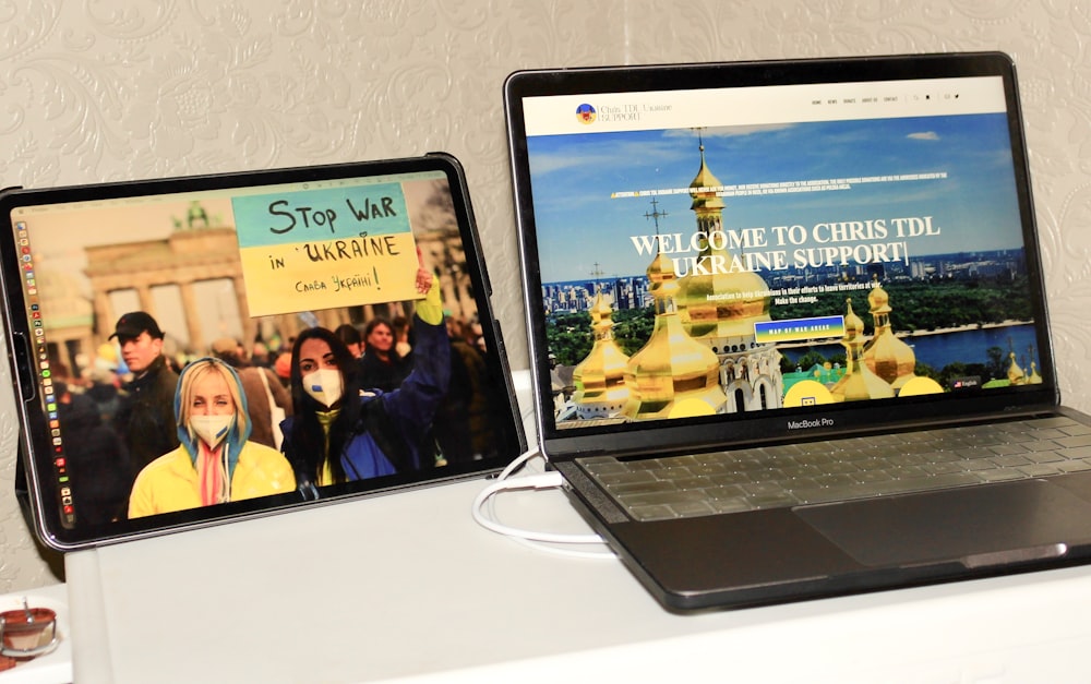 two laptops sitting side by side on a table