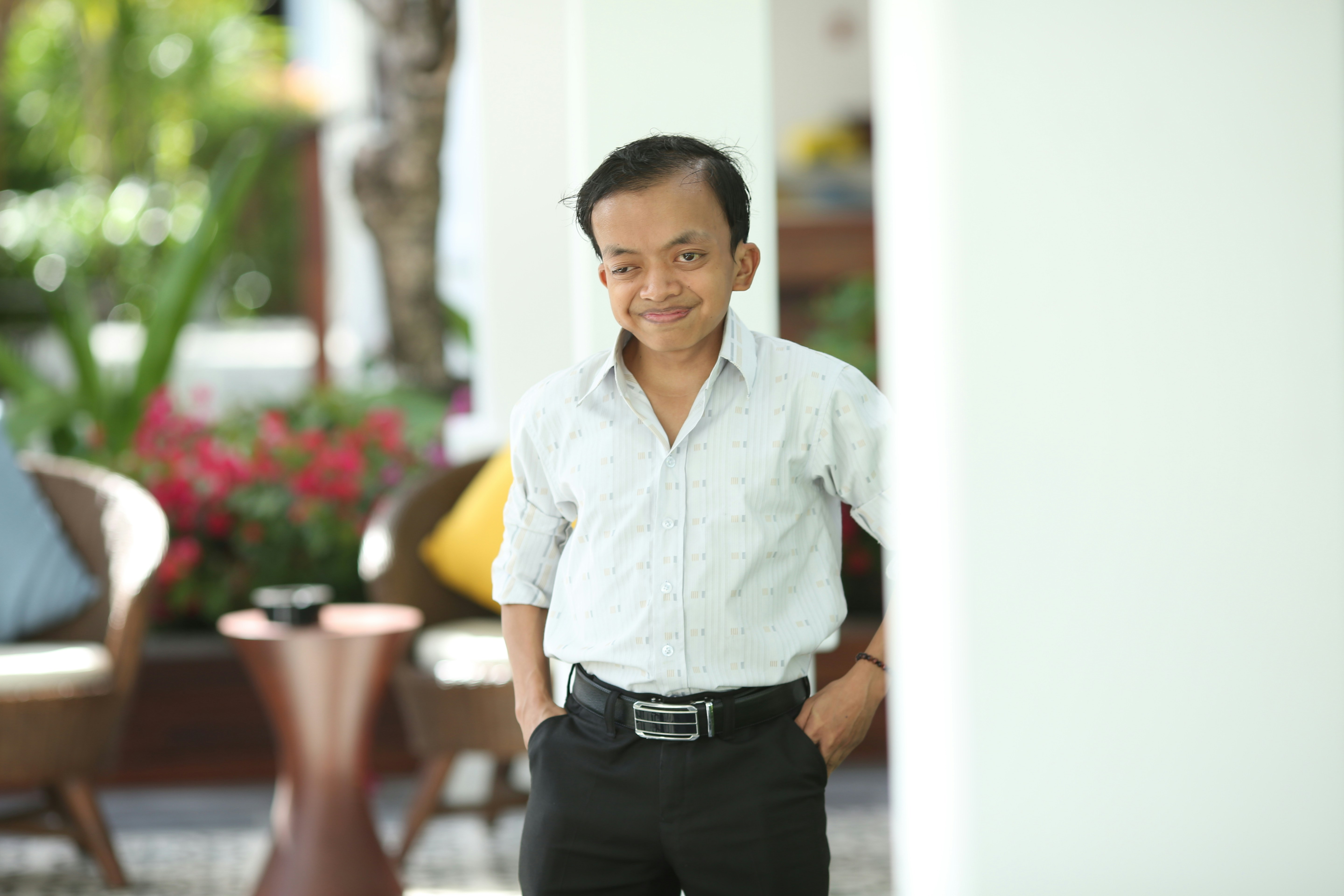 a man in a white shirt and black pants