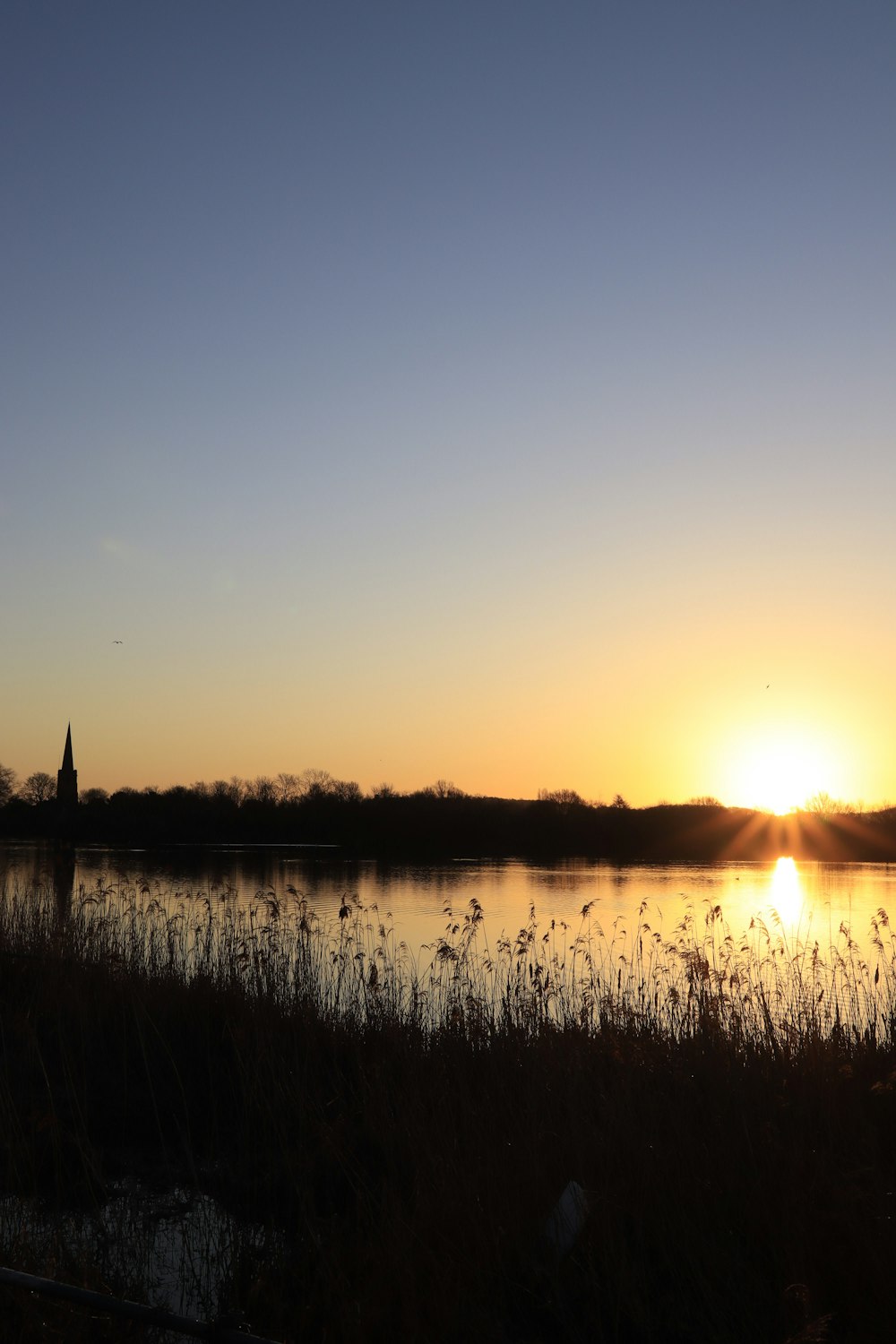 the sun is setting over a body of water