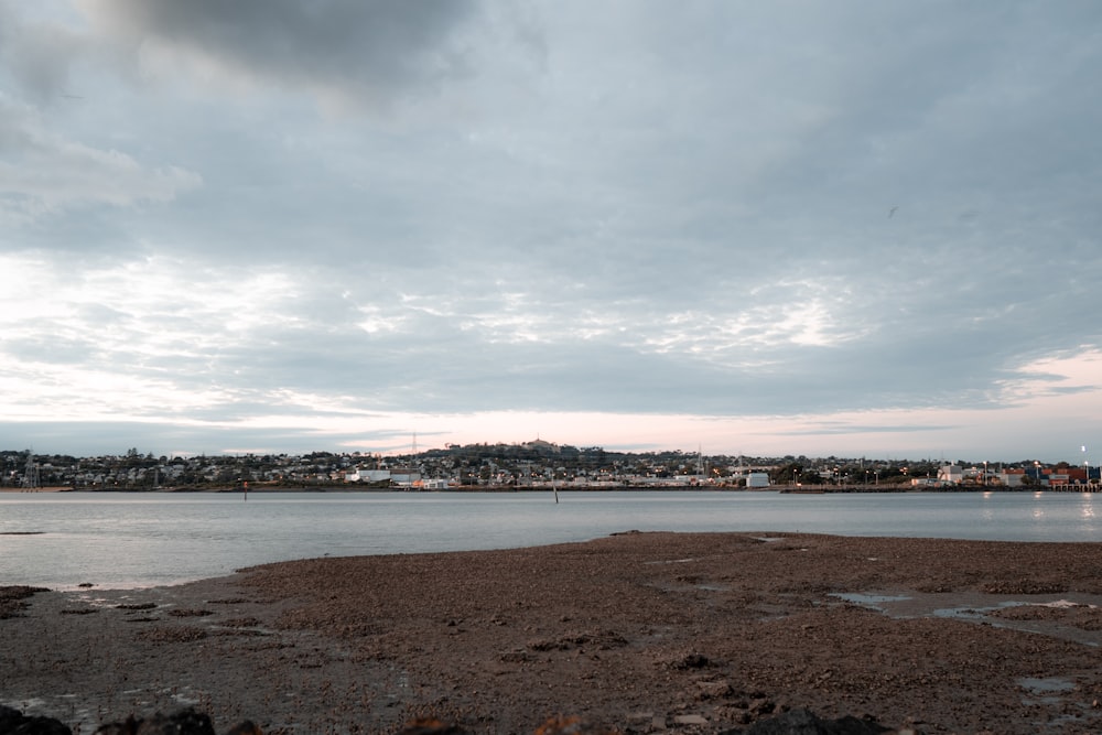 a body of water with a city in the background