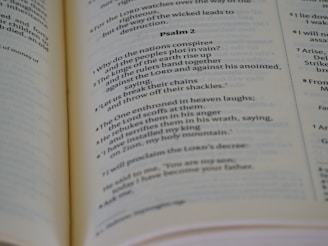 Open book displaying printed text, specifically a passage from a psalm, with a focus on neat typography and verses marked in sequence. The book is laid out on a flat surface with visible binding.