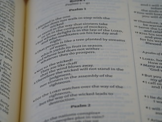 A close-up view of a printed page from a Bible, with text from Psalm 1 and Psalm 2. The text is clearly legible and the page is lit evenly, showing the structure and layout of the biblical text.