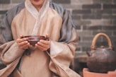 a woman holding a bowl in her hands