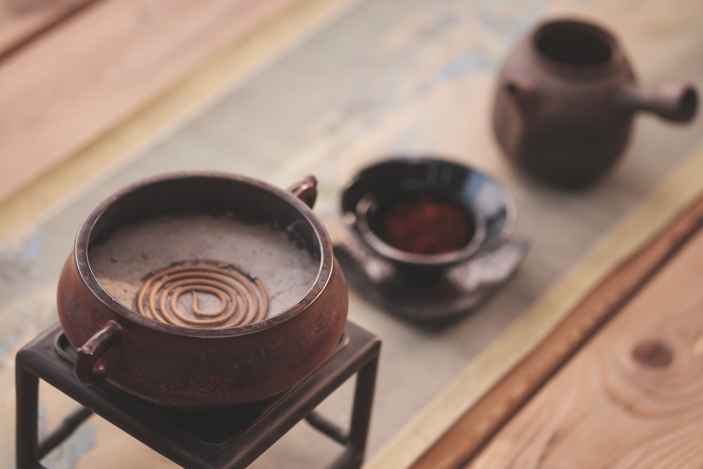 a tea pot sitting on top of a wooden table