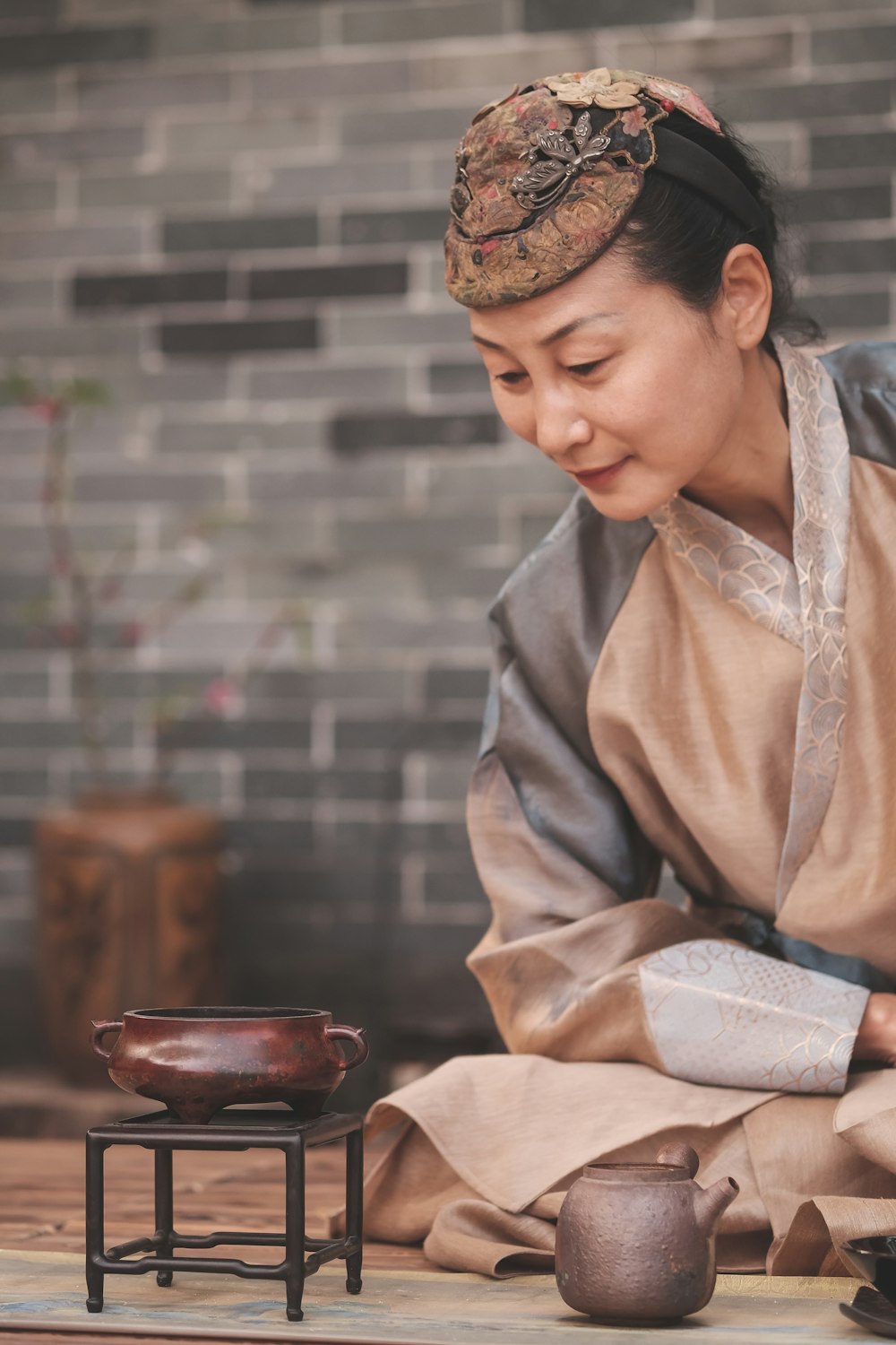 a woman in a kimono is preparing food