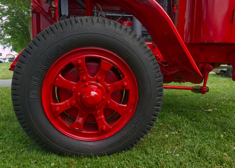 a close up of a red wheel on a red truck
