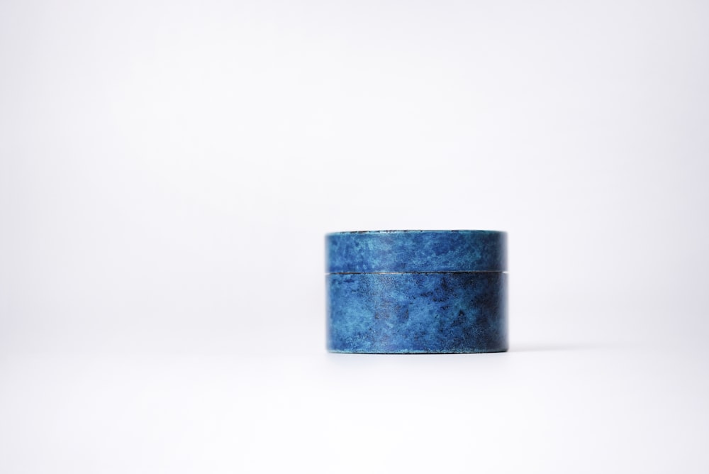 a blue box sitting on top of a white surface
