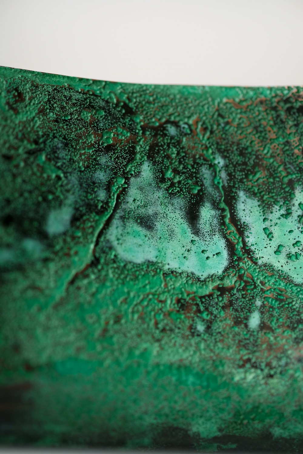 a close up of a green and black object