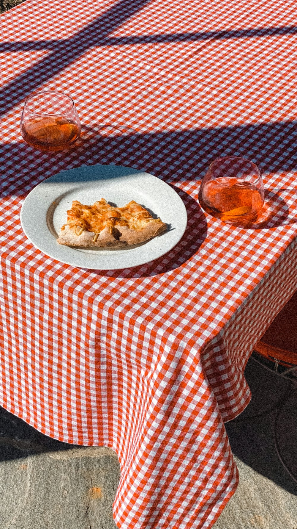 a plate of pizza on a checkered table cloth