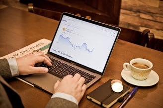 a person using a laptop on a wooden table