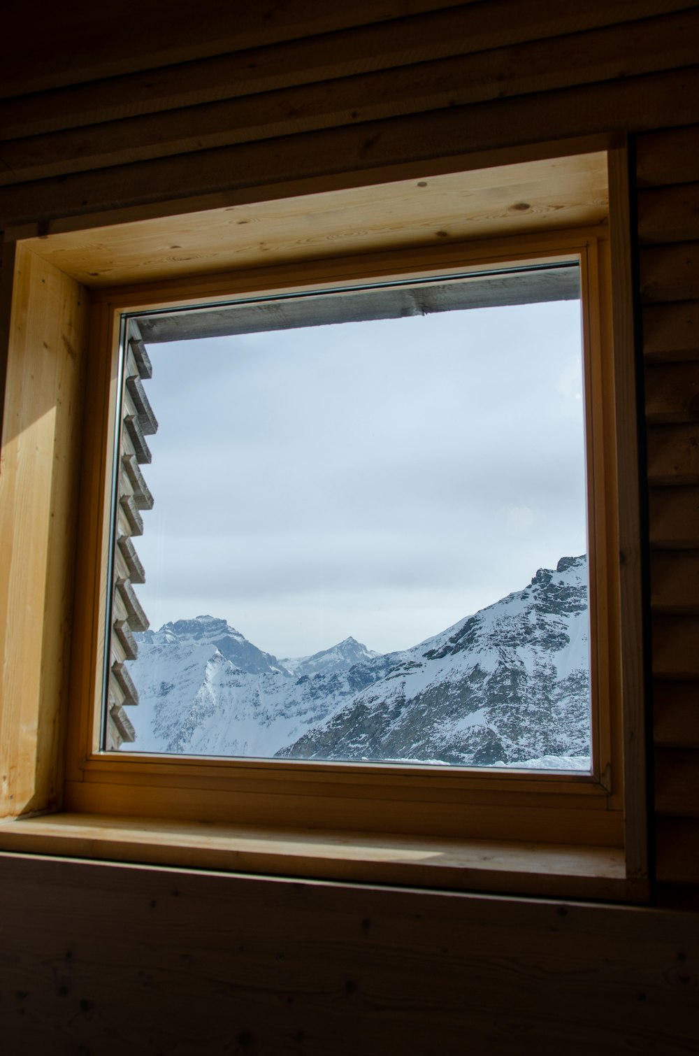 a window with a view of a snowy mountain